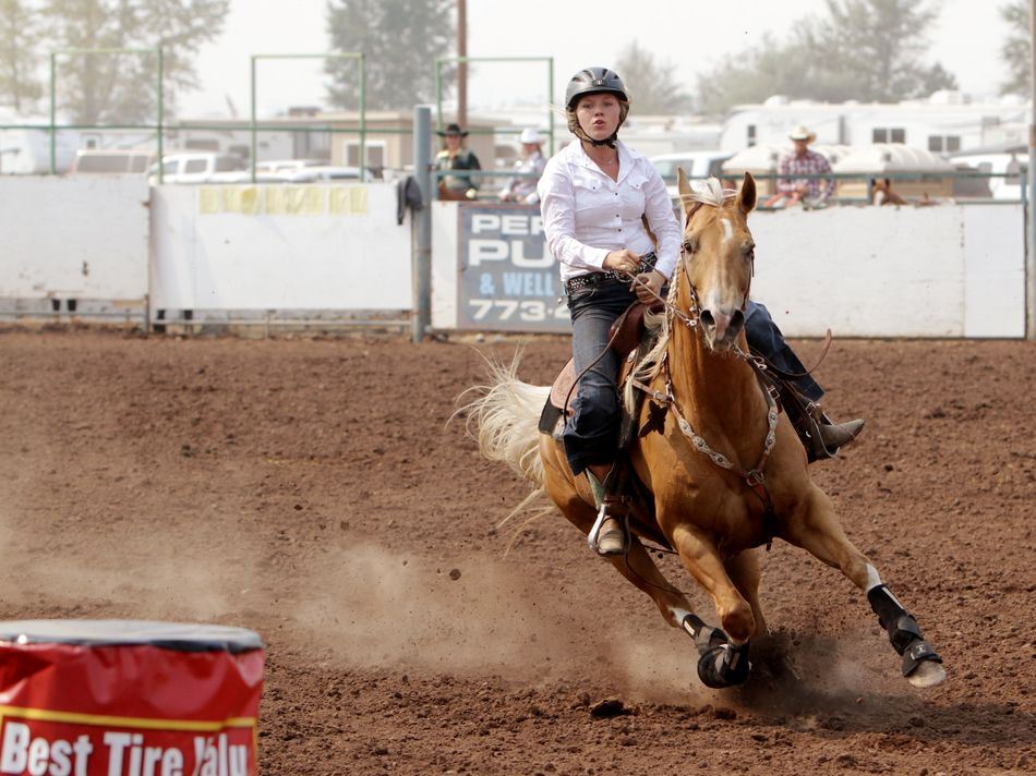 A woman runs barrel races on her horse during the 2015 Klickitat County Fair Rodeo.
