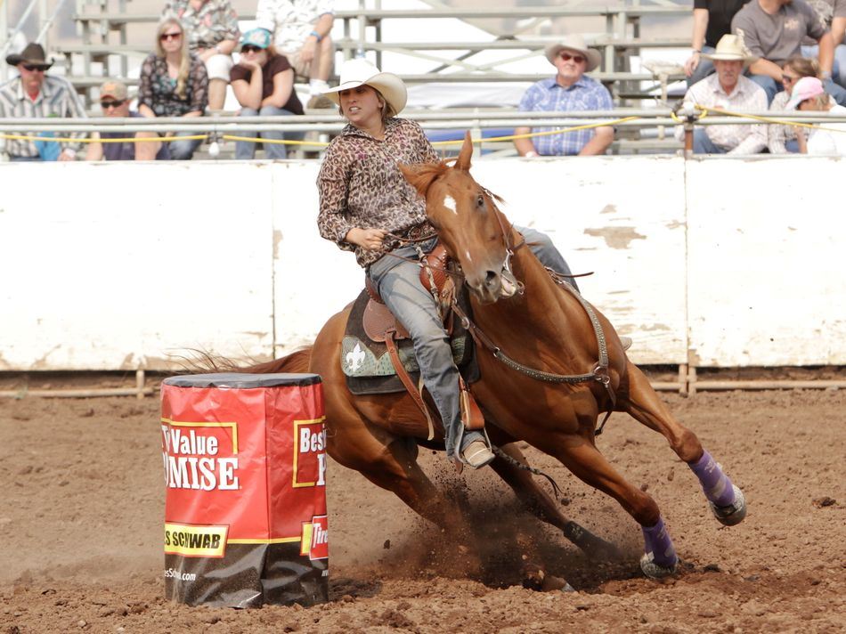 A woman runs barrel races on her horse during the 2015 Klickitat County Fair Rodeo.