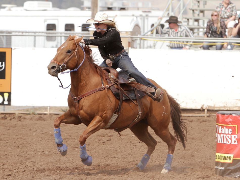 A woman runs barrel races on her horse during the 2015 Klickitat County Fair Rodeo.