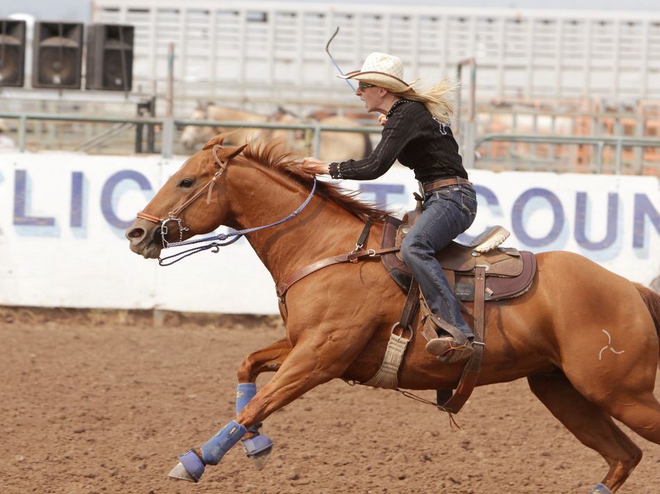 A woman runs barrel races on her horse during the 2015 Klickitat County Fair Rodeo.