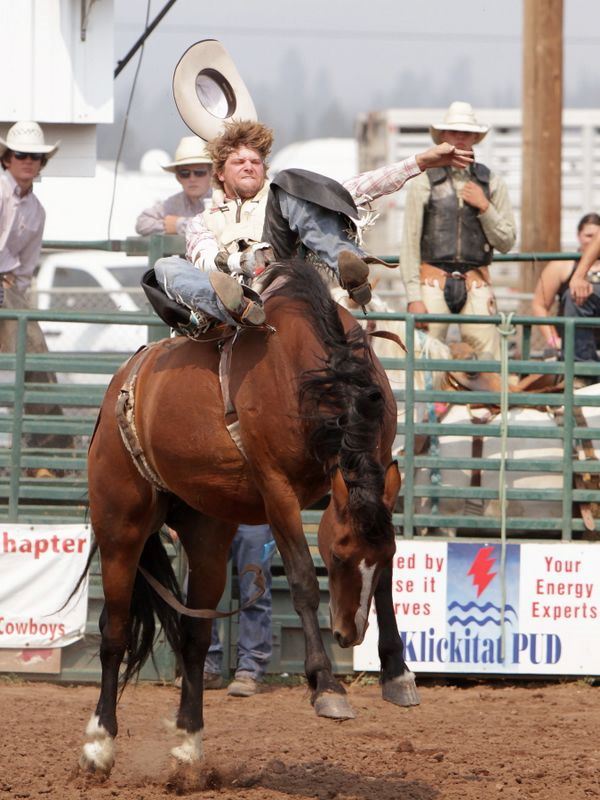 A man loses his hat riding a bucking horse at the 2015 Klickitat County Fair Rodeo.