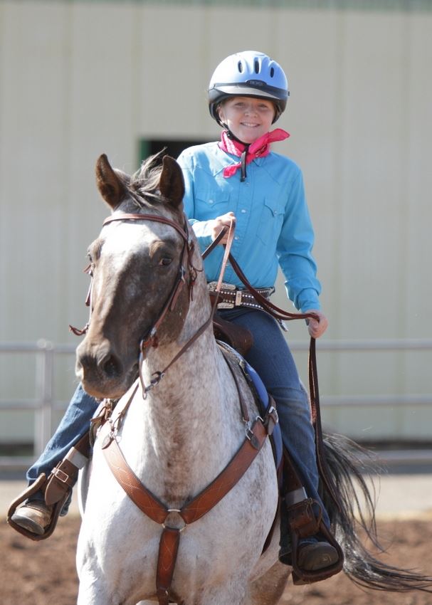 A young woman rides her horse in the arena at the 2014 Klickitat County Fair.