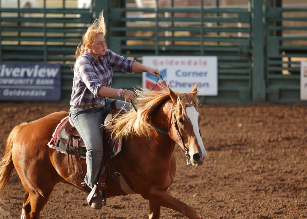 A young woman rides her horse in the arena at the 2014 Klickitat County Fair.