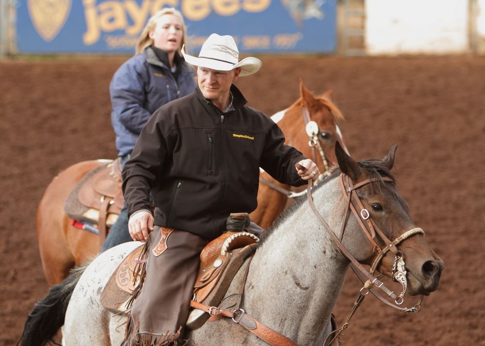 A man and woman sit on their horses in the arena at the 2014 Klickitat County Fair.