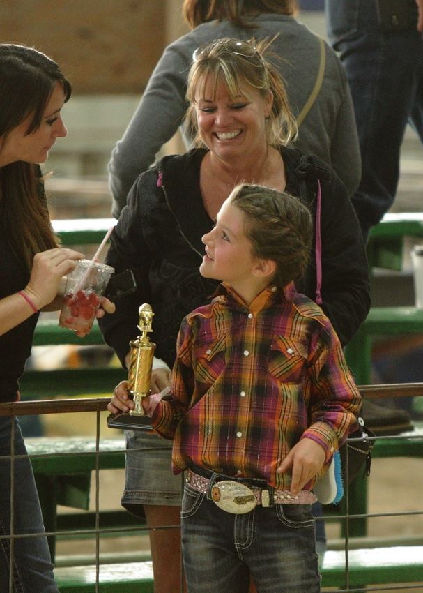 A little girl holds a trophy at the 2014 Klickitat County Fair.