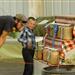 A little boy and man stand next to a grain display at the 2014 Klickitat County Fair.