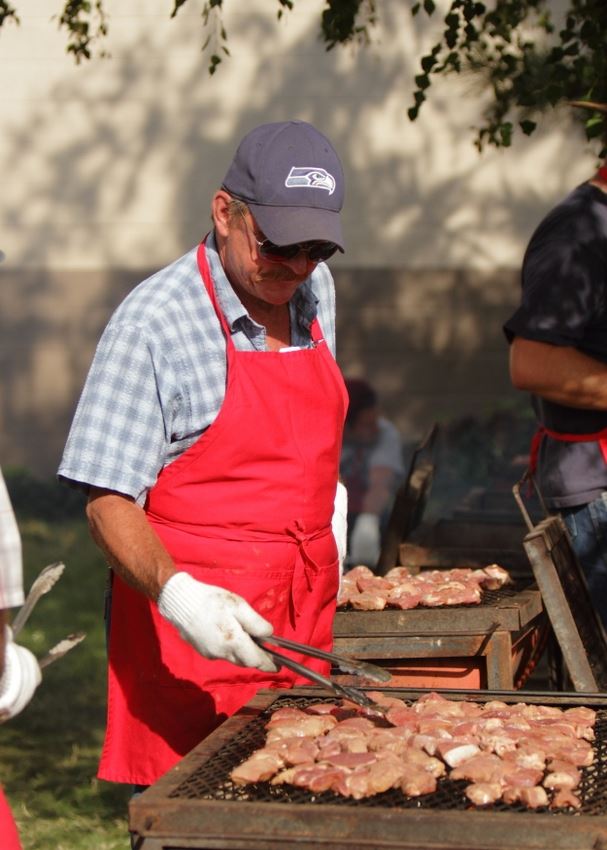 A man cooks food to serve at the 2014 Klickitat County Fair.
