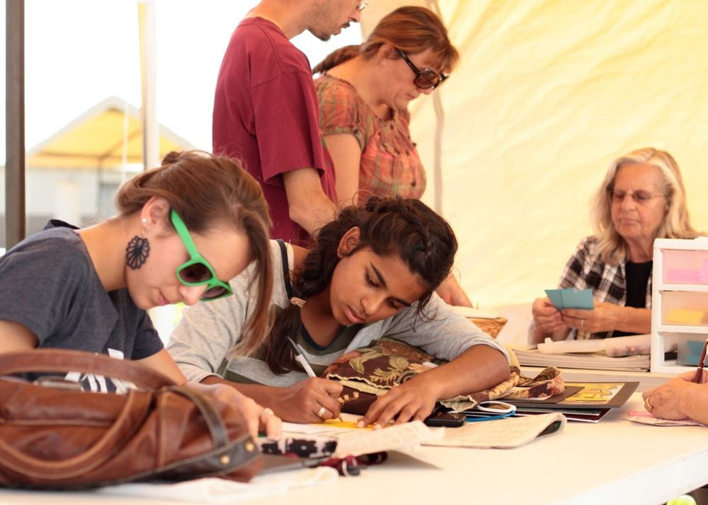 Girls write on paper at an exhibit for the 2014 Klickitat County Fair.