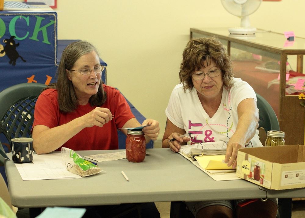 Two women sit at an exhibit for the 2014 Klickitat County Fair.