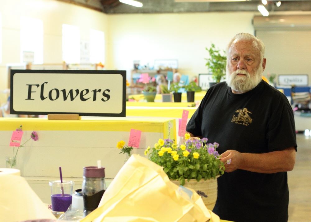 A man shows flowers at a flower exhibit at the 2014 Klickitat County Fair.
