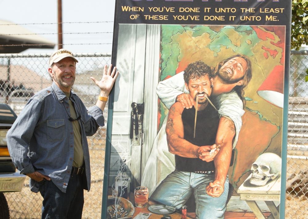 A man stands next to an anti-drug image at the 2014 Klickitat County Fair.