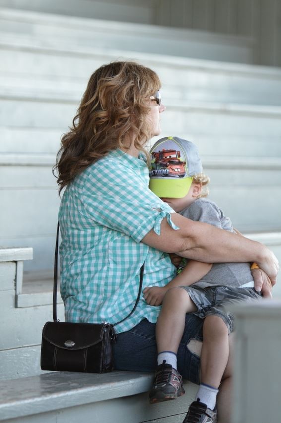 A woman holds a sleeping toddler at the 2014 Klickitat County Fair.