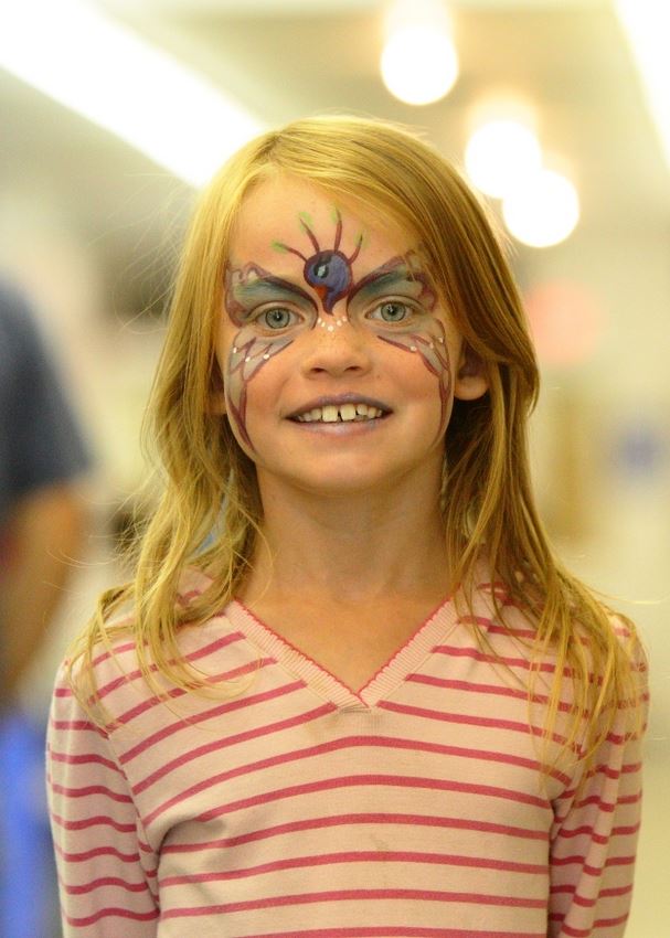 A little girl has her face painted at the 2014 Klickitat County Fair.