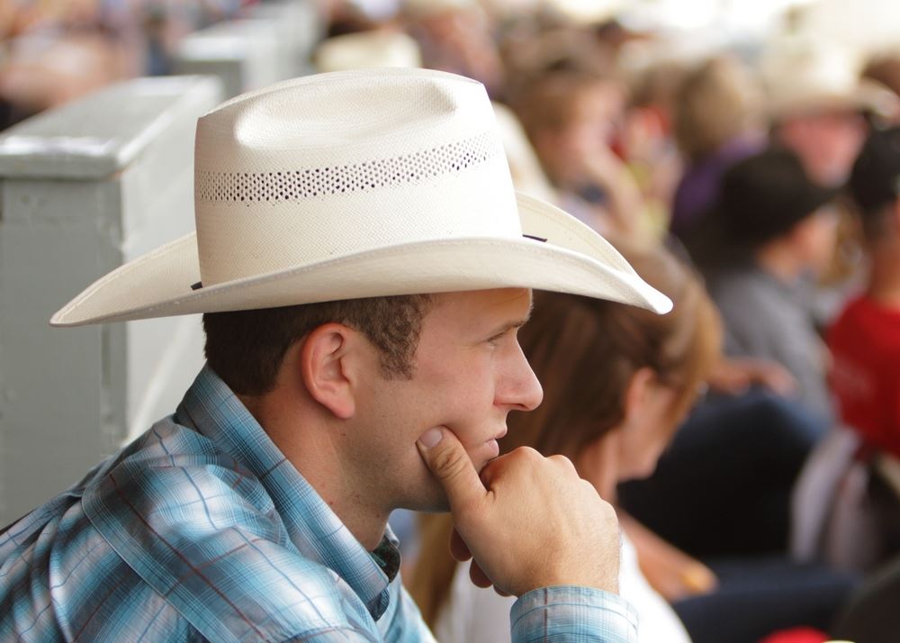 A man in a cowboy hat sits among the 2014 Klickitat County Fair.