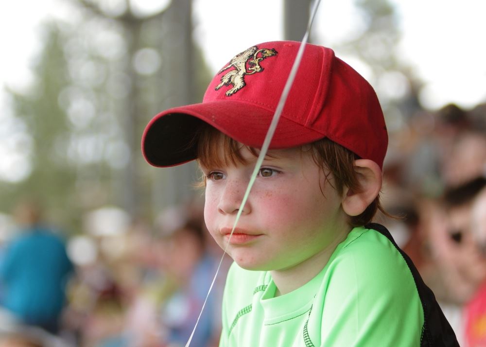A little boy sits among the crowd at the 2014 Klickitat County Fair.