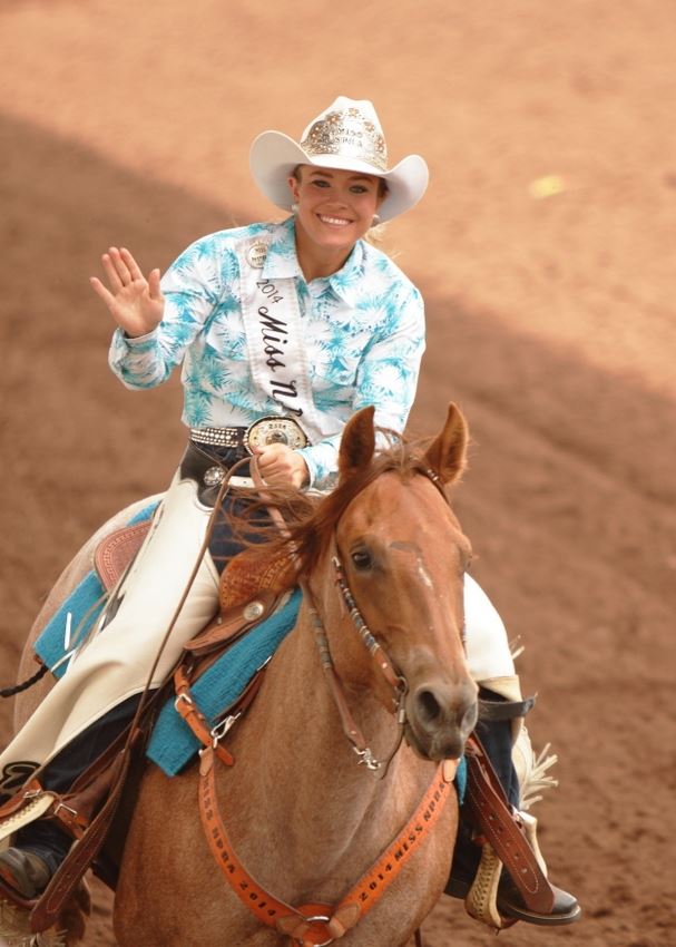 A rodeo queen rides by on her horse and waves to the crowd at the 2014 Klickitat County Fair Rodeo.