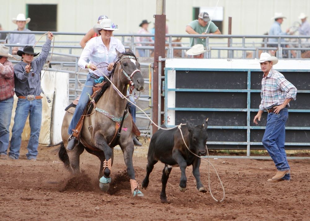 A woman lassos a running calf at the 2014 Klickitat County Fair Rodeo.