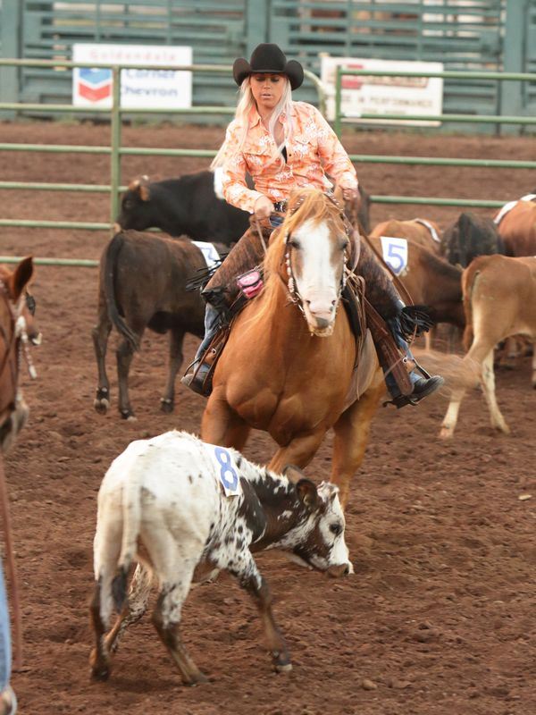 A young woman herds calves on her horse at the 2015 Klickitat County Fair.