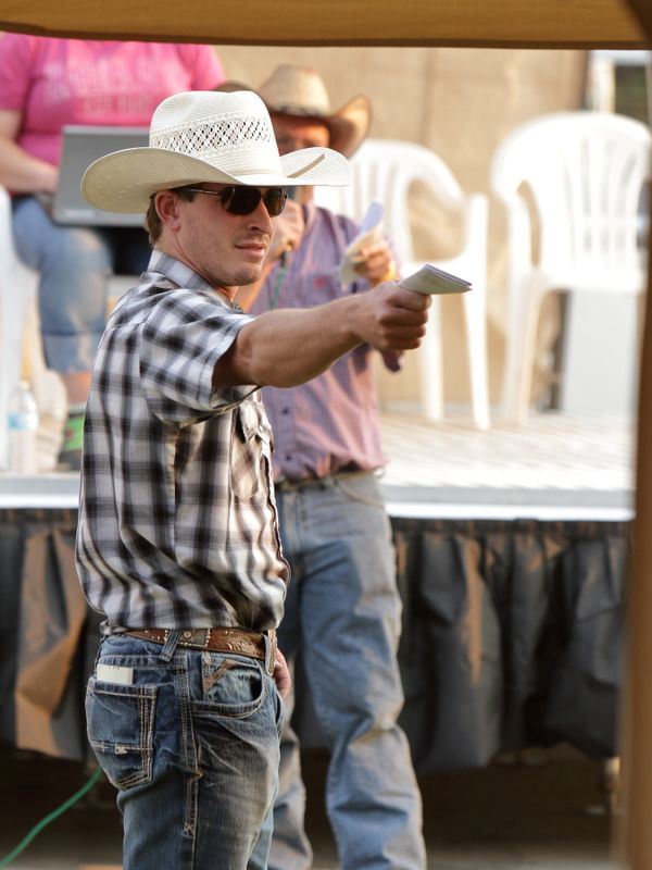Man helps with an auction at the 2015 Klickitat County Fair.