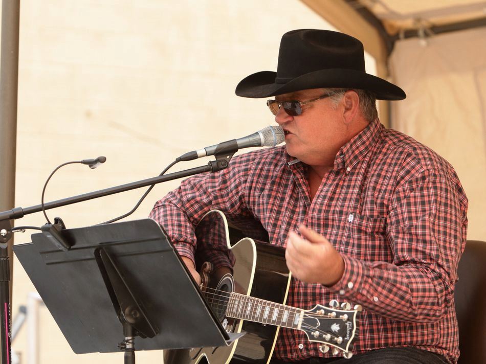 Man sings and plays his acoustic guitar for the crowd at the 2015 Klickitat County Fair.