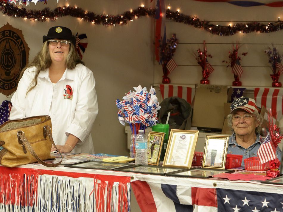 Women sit at a booth at the 2015 Klickitat County Fair.