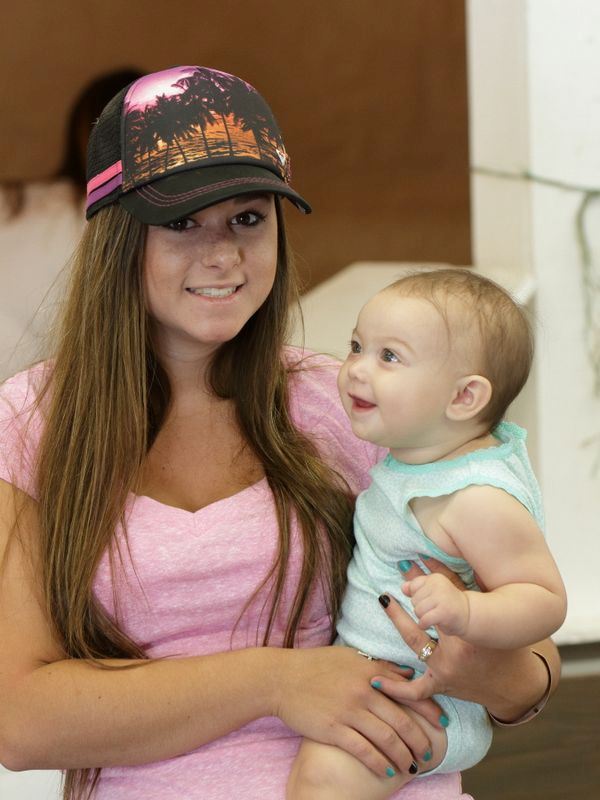 A young woman holds a smiling baby at the 2015 Klickitat County Fair.