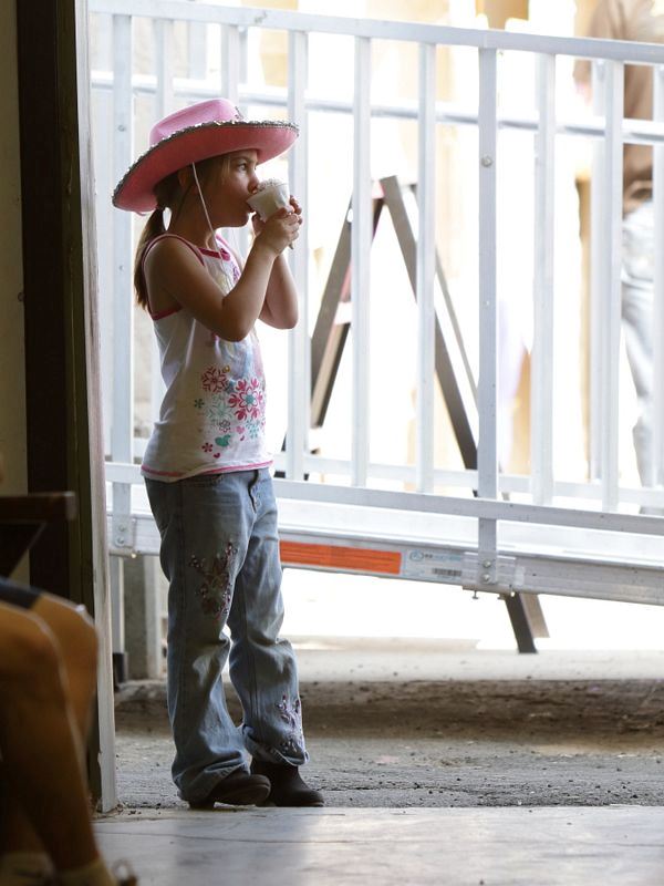 A little girl eats her snow cone at the 2015 Klickitat County Fair.