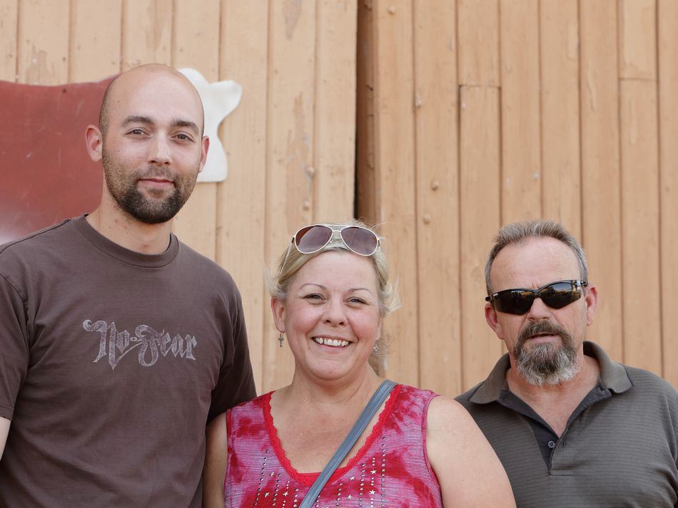 Two men and a woman attend the 2015 Klickitat County Fair together.