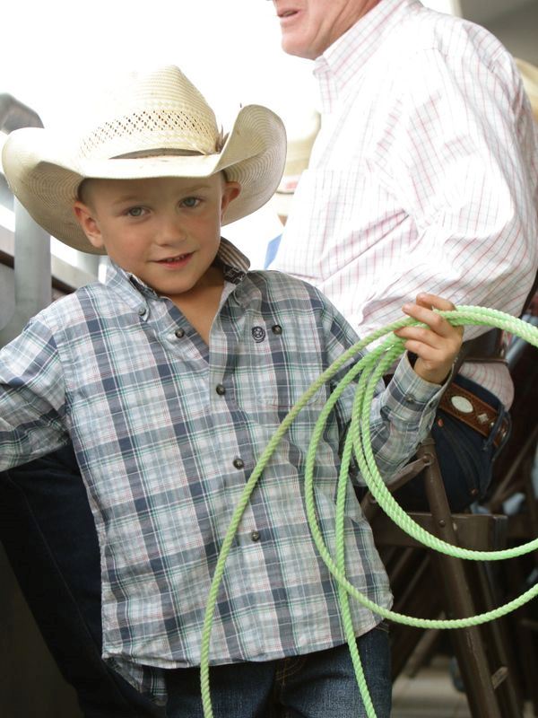 A little boy holds a rope at the 2015 Klickitat County Fair.