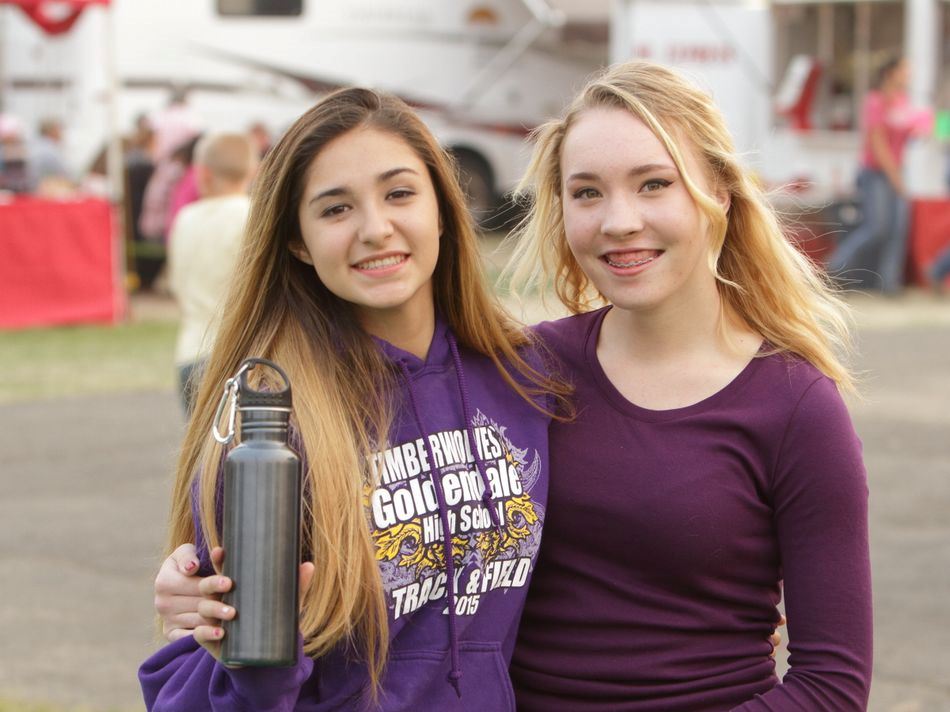 Two teen girls stand together at the 2015 Klickitat County Fair.