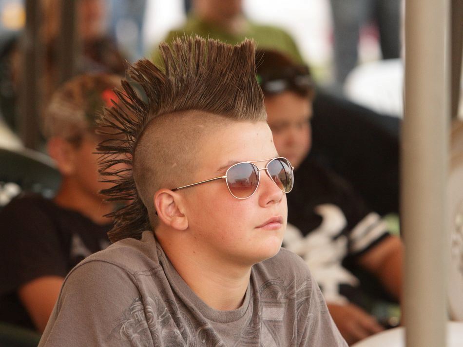 A boy with a mohawk sits among the crowd at the 2015 Klickitat County Fair.