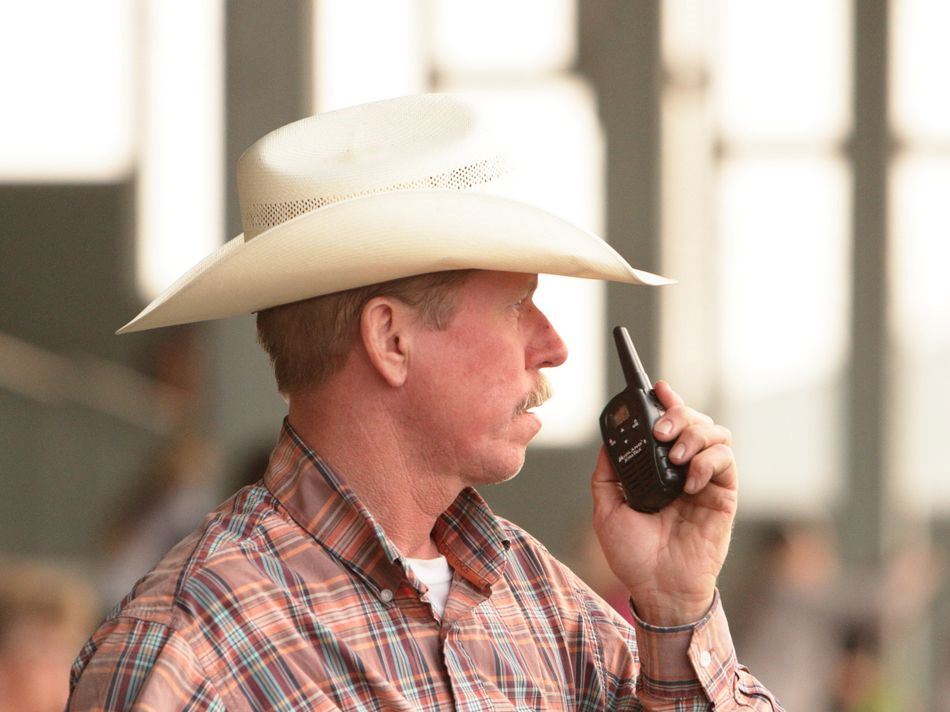 A man speaks into a walkie talkey at the 2015 Klickitat County Fair.