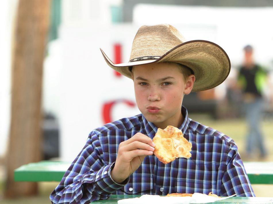 A little boy eating at the 2015 Klickitat County Fair.