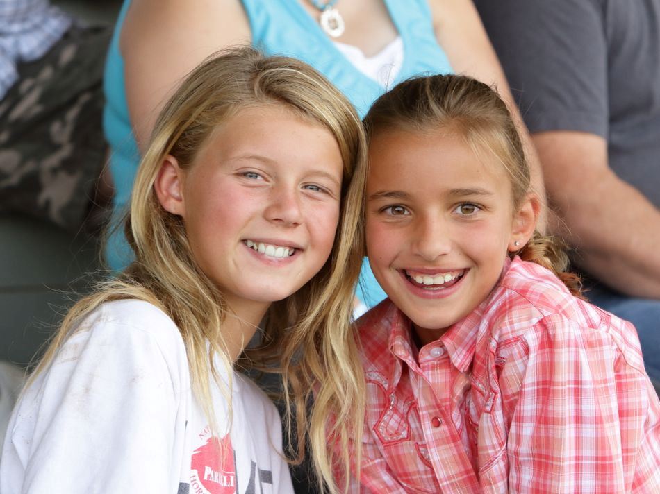 Two little girls sit together at the 2015 Klickitat County Fair.